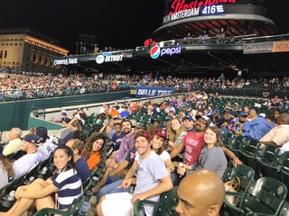 students in seats at a baseball game